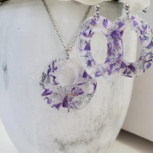 Load image into Gallery viewer, Handmade real flower circular pendant necklace accompanied by a pair of oval stud drop earrings made with statice and silver flakes preserved in resin. - Flower Jewelry, Purple Jewelry, Jewelry Sets