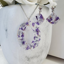 Load image into Gallery viewer, Handmade real flower oval pendant necklace accompanied by a pair of shell shape stud earrings made with purple statice and silver flakes preserved in resin. - Jewelry Sets, Flower Jewelry, Blue Jewelry