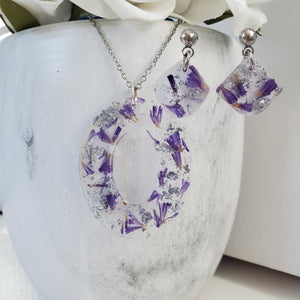Handmade real flower oval pendant necklace accompanied by a pair of shell shape stud earrings made with purple statice and silver flakes preserved in resin. - Jewelry Sets, Flower Jewelry, Blue Jewelry