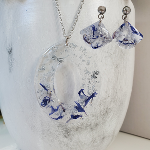Handmade real flower oval pendant necklace accompanied by a pair of shell shape stud earrings made with blue cornflower and silver flakes preserved in resin. - Jewelry Sets, Flower Jewelry, Blue Jewelry