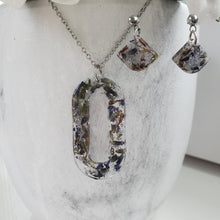 Load image into Gallery viewer, Handmade real flower oval pendant necklace accompanied by a matching pair of dangling stud earrings made with lavender petals and silver flakes preserved in resin. - Red Jewelry, Jewelry Sets, Flower Jewelry
