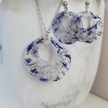 Load image into Gallery viewer, Handmade real flower circular pendant necklace accompanied by a matching pair of stud earrings made with blue cornflower and silver leaf preserved in resin. - Resin Jewelry, Bridal Sets, Jewelry Sets