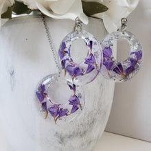 Load image into Gallery viewer, Handmade real flower circular pendant necklace accompanied by a matching pair of stud earrings made with purple statice and silver leaf preserved in resin. - Resin Jewelry, Bridal Sets, Jewelry Sets