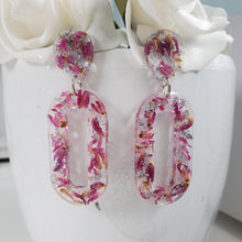 Load image into Gallery viewer, Handmade real flower long oval dangle earrings made with red clover flowers and silver leaf preserved in resin. - Flower Earrings, Blue Earrings, Resin Jewelry