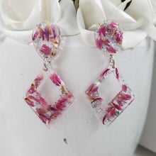 Load image into Gallery viewer, Handmade real flower long triangle stud earrings made with red clover flowers and silver leaf preserved in resin.